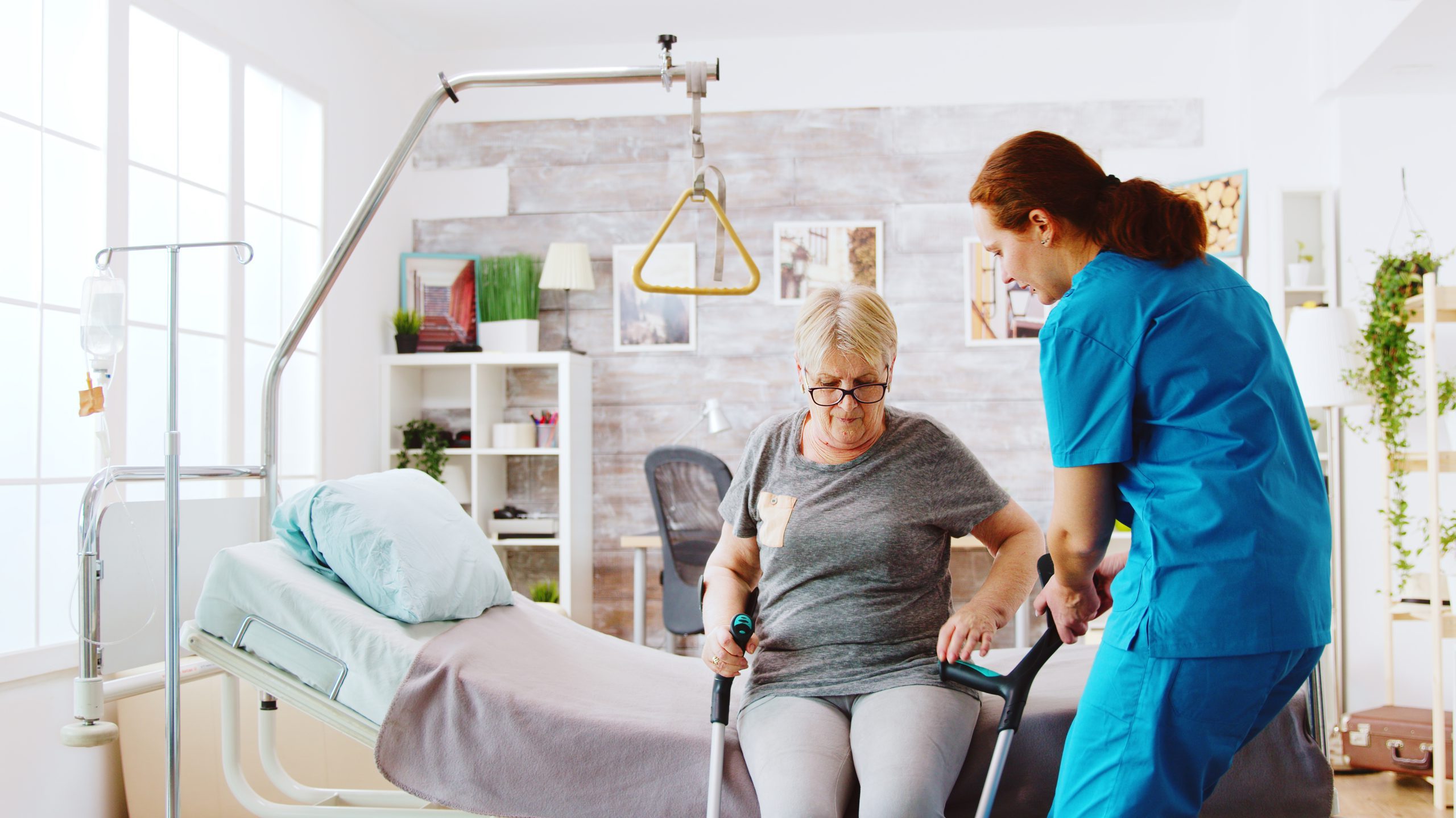 Older adult receiving mobility support from a care worker